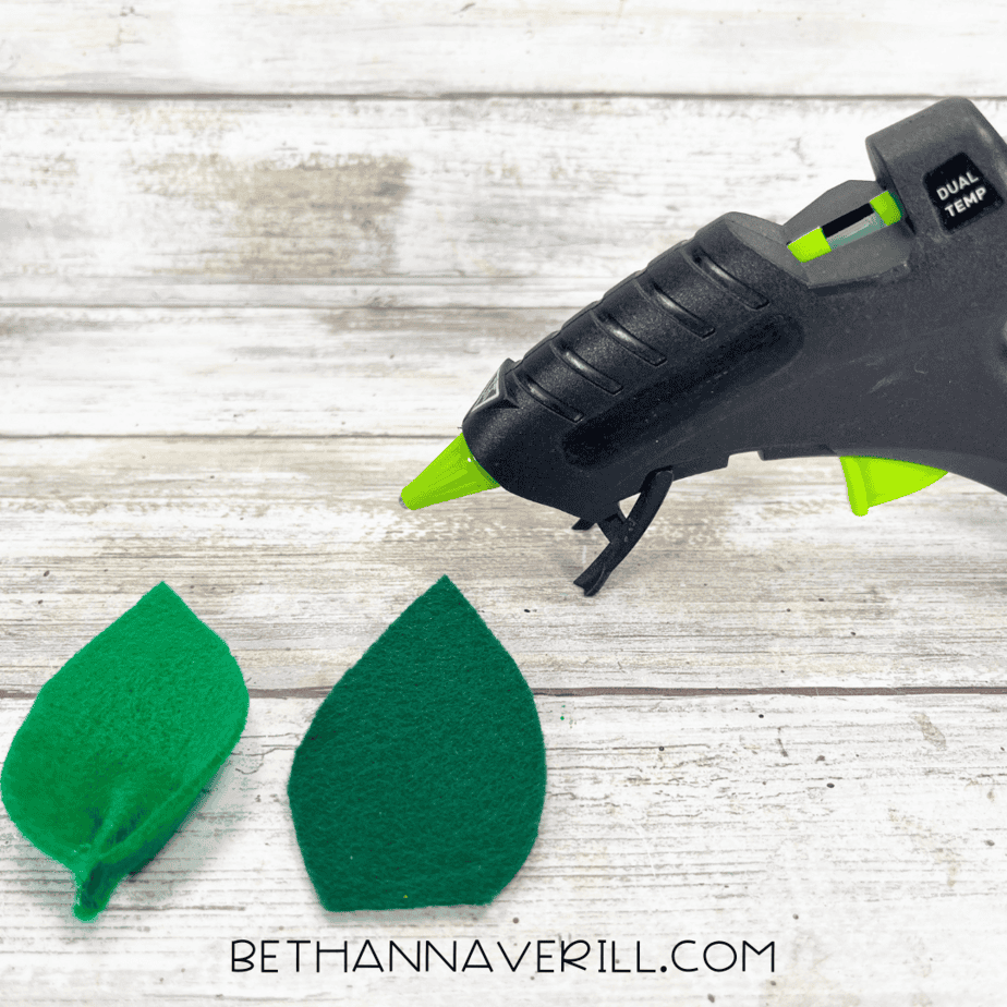 Two green felt leaves, one pinched and glued for shape.
