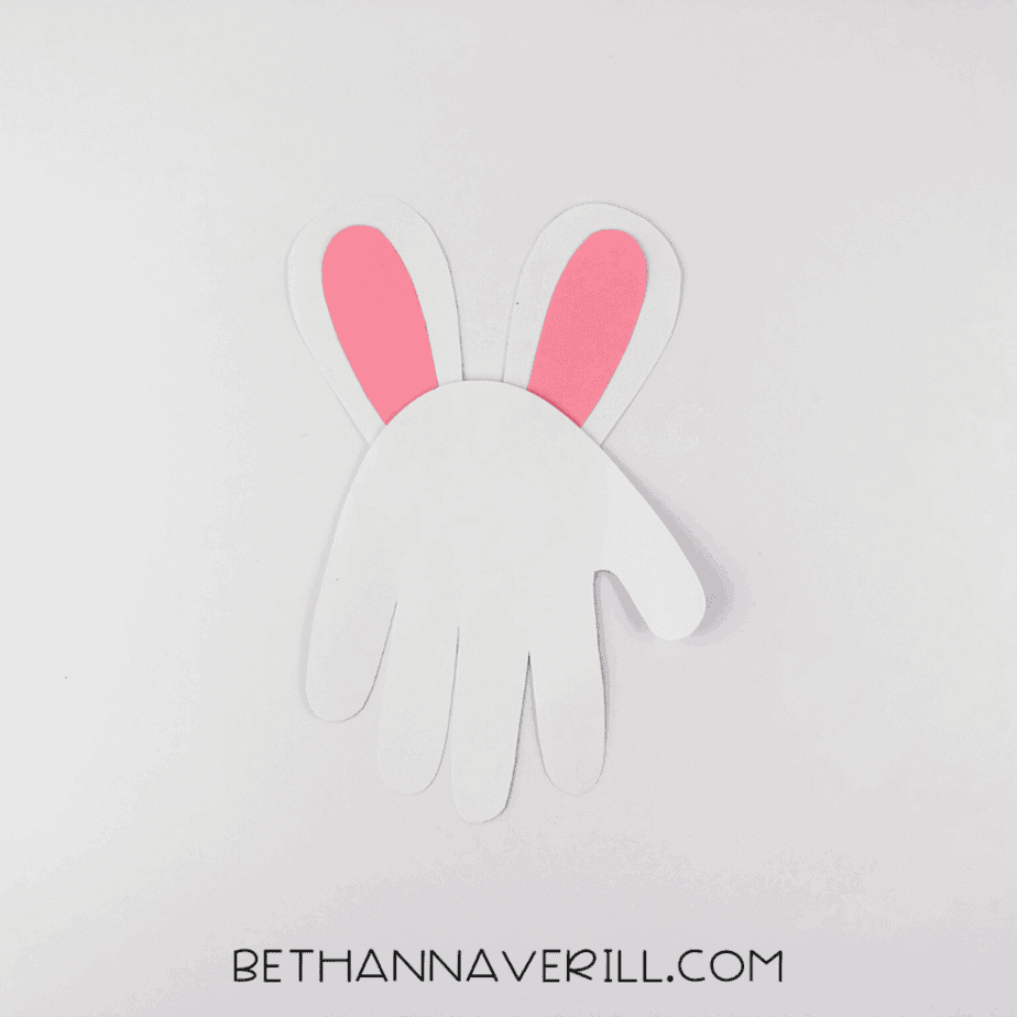 Ears glued to the back of the white handprint base.