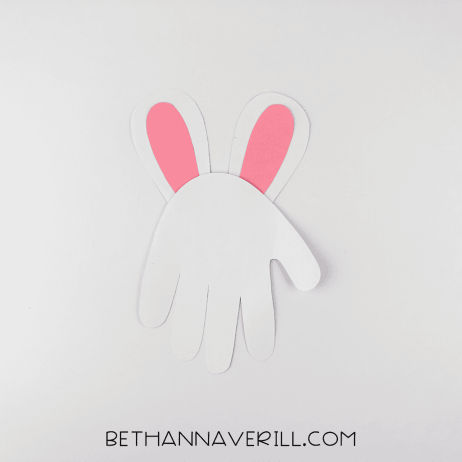 Ears glued to the back of the white handprint base.