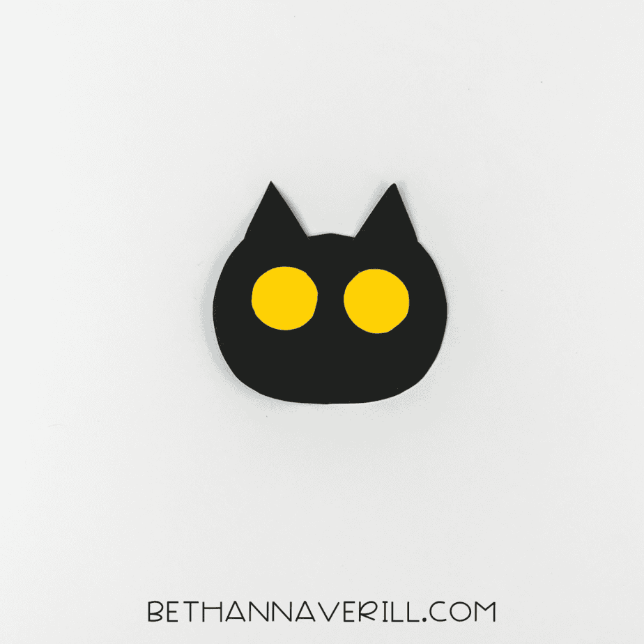 Yellow eyes glued to black cat head