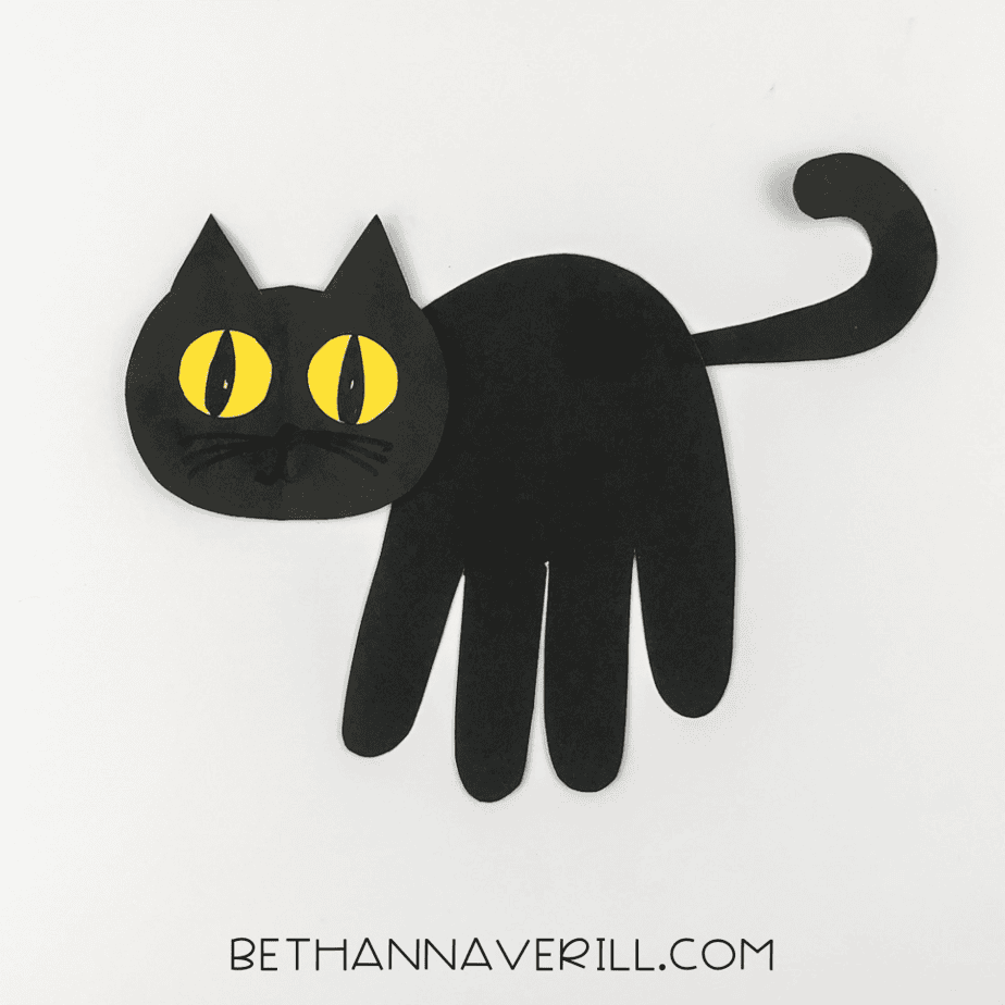 Final black cat handprint craft with tail attached