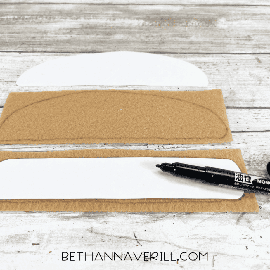 Tan felt with bun shapes traced using a marker.
