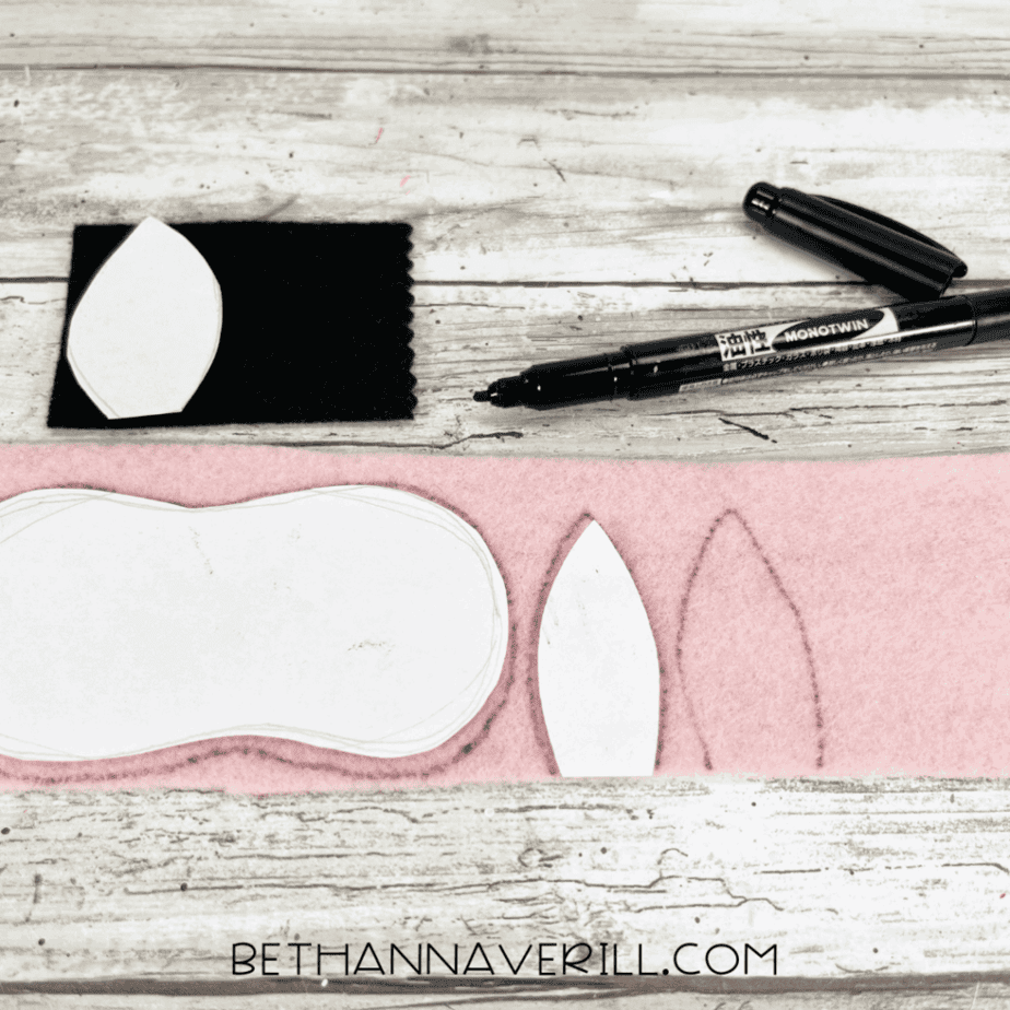 Pink and black felt pieces traced with ear and snout templates.