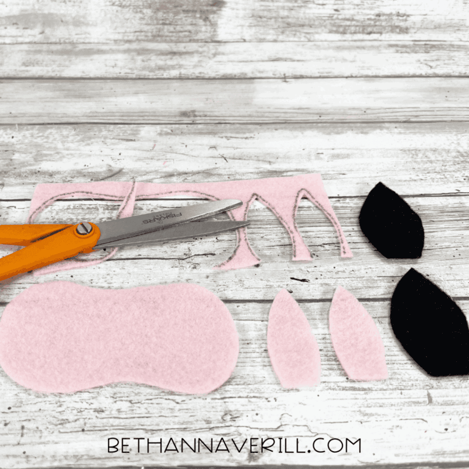 Felt cow ears and snout cut out with scissors.