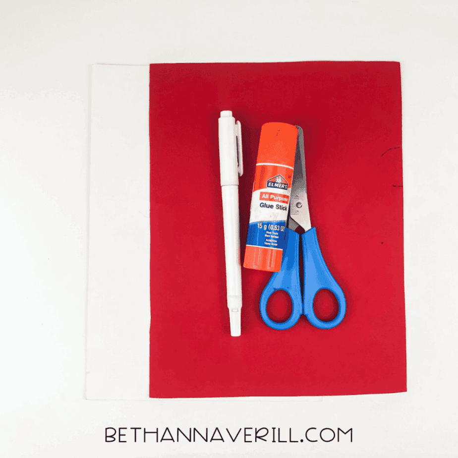 Craft materials: red and white paper, scissors, glue stick, black marker
