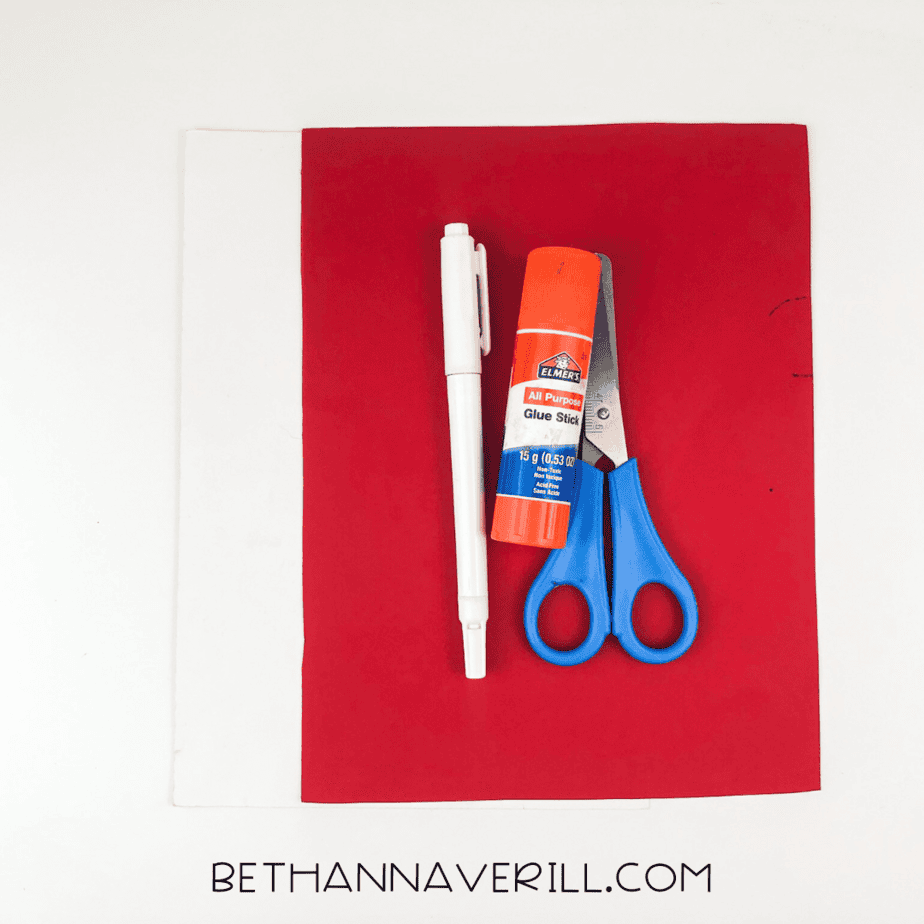 Craft materials: red and white paper, scissors, glue stick, black marker