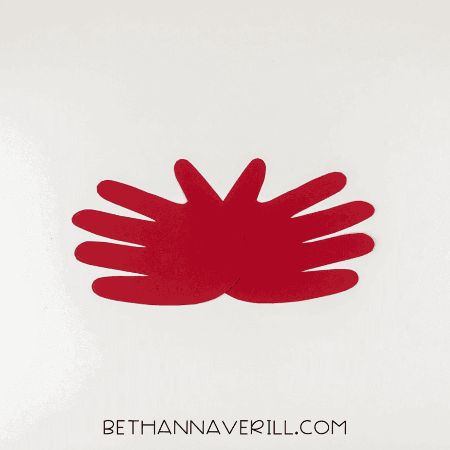 Red handprints arranged with palms overlapping to form the crab's body