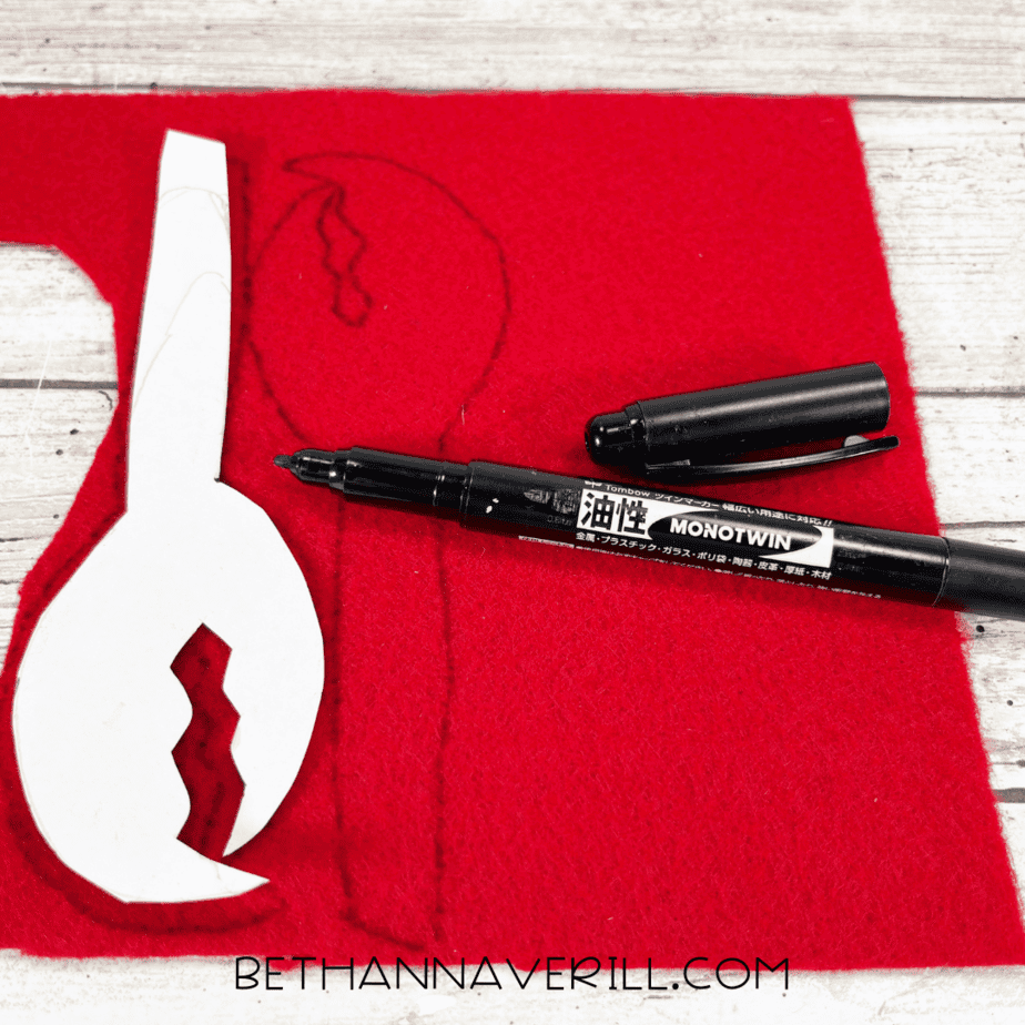 Crab claw template traced on red felt.