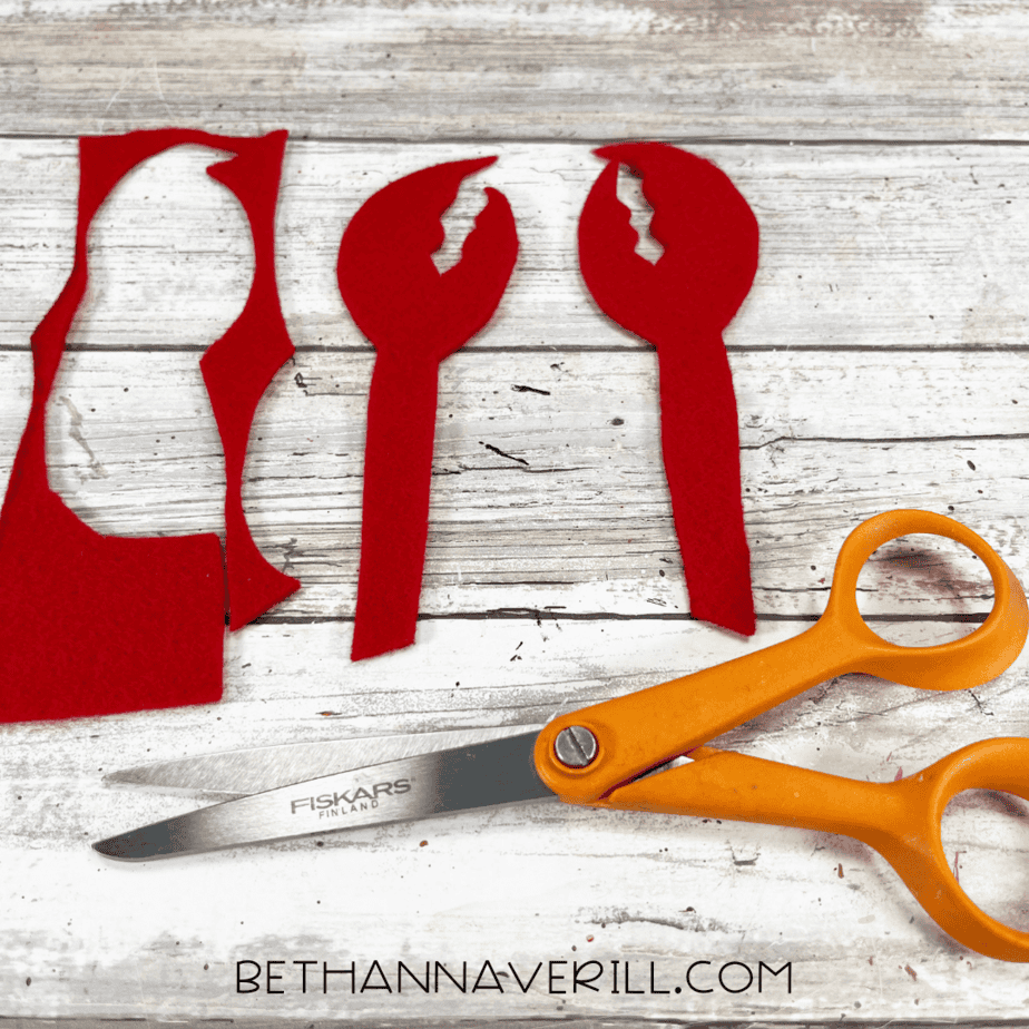 Red felt claws cut out for crab craft.