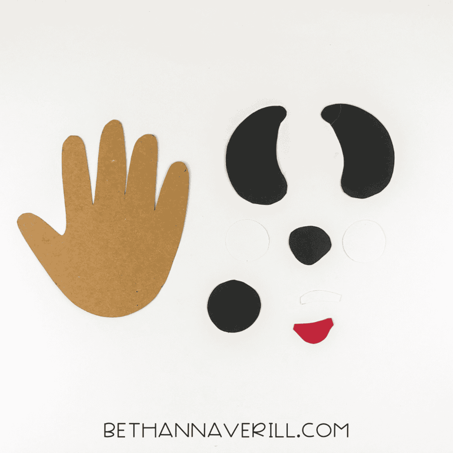 Cut pieces: brown handprint, ears, eyes, nose, mouth, spot