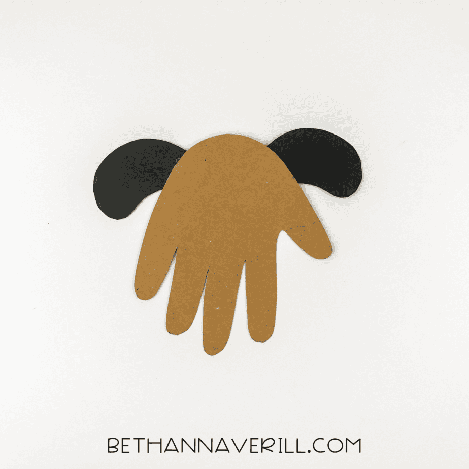 Ears glued behind the handprint