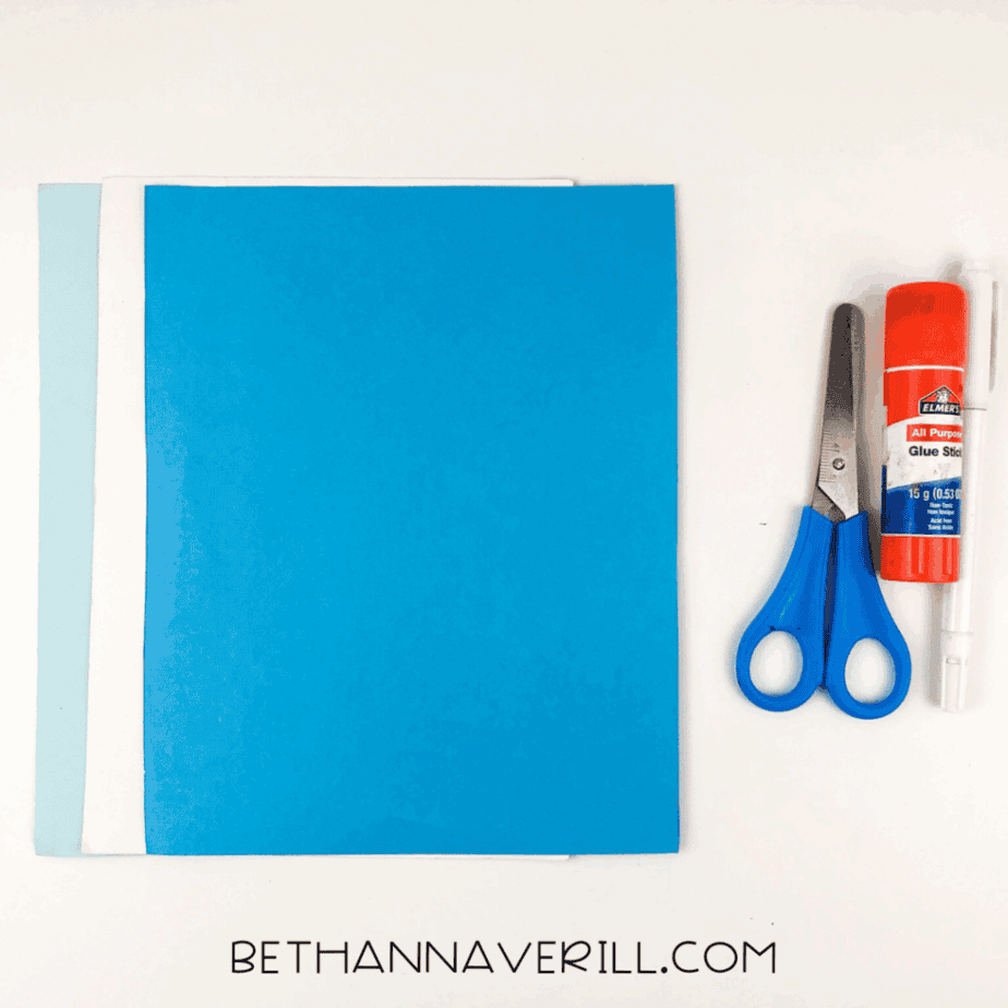 Materials needed for elephant handprint craft: colored paper, scissors, glue stick, black marker