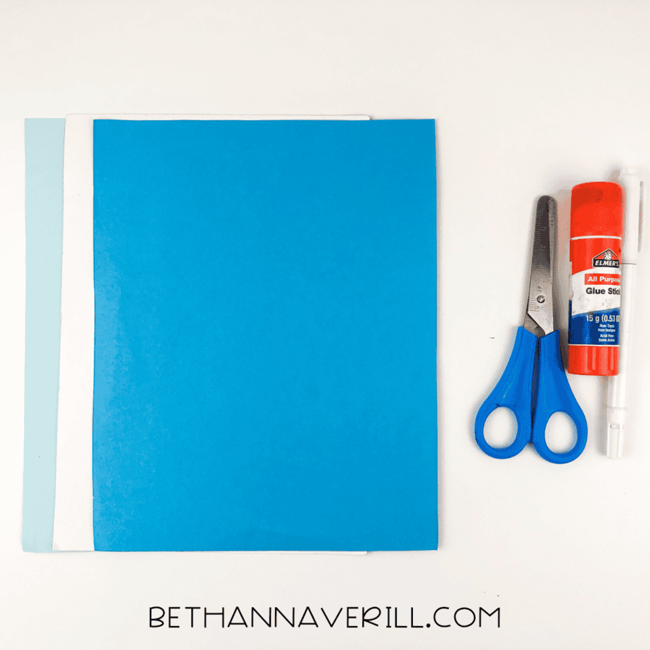 Materials needed for elephant handprint craft: colored paper, scissors, glue stick, black marker