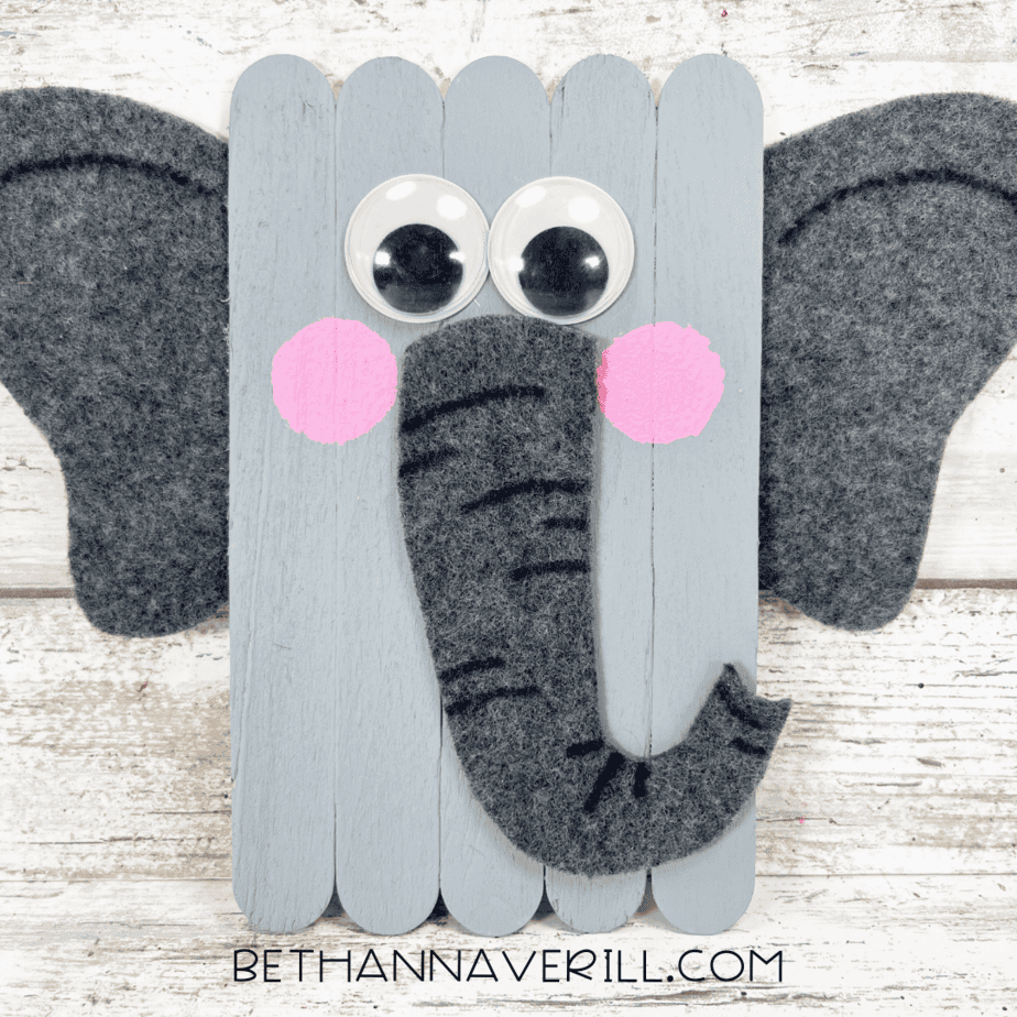 Finished popsicle stick elephant craft with googly eyes, pink cheeks, and felt trunk and ears.