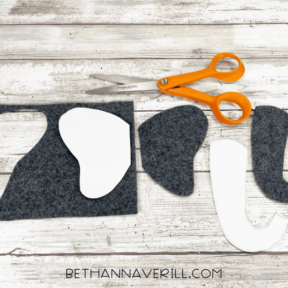 Felt elephant ears and trunk pieces cut out with scissors on the table.