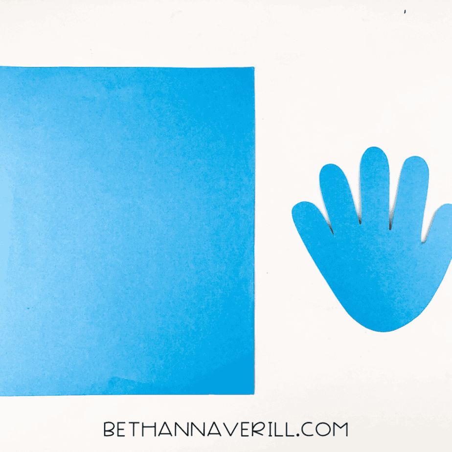 Blue construction paper with a blue handprint cutout