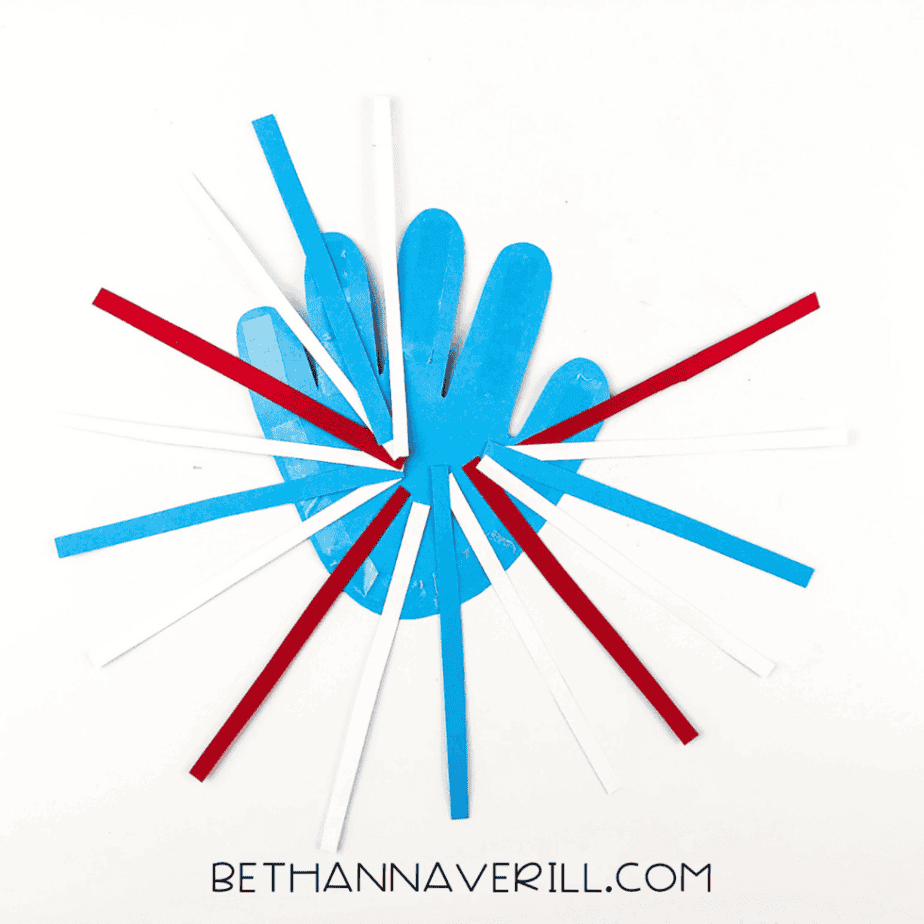Blue handprint with red, white, and blue strips glued in a starburst pattern