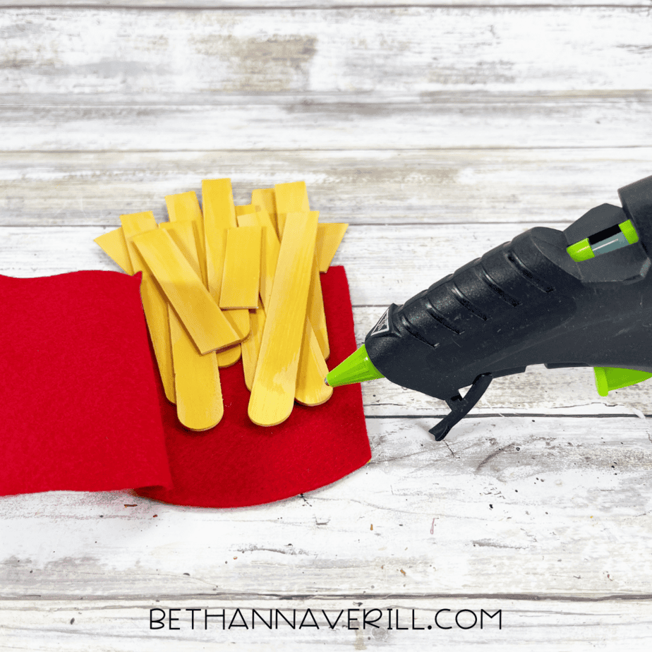 More painted sticks glued into container to look like fries.