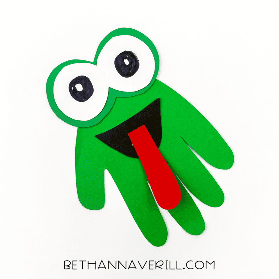 Finished frog handprint craft with big eyes and red tongue