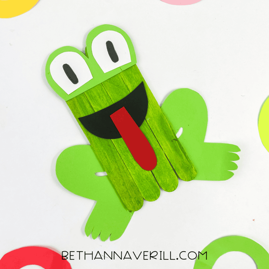 Finished frog craft with fun paper background decorations.