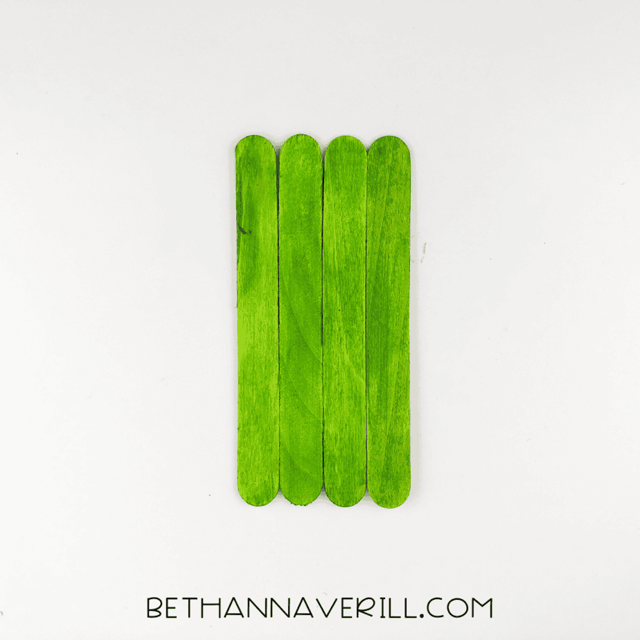 Four green popsicle sticks glued side by side.