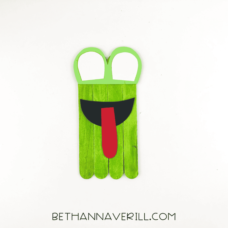 Frog eyes and mouth glued to the popsicle stick base.