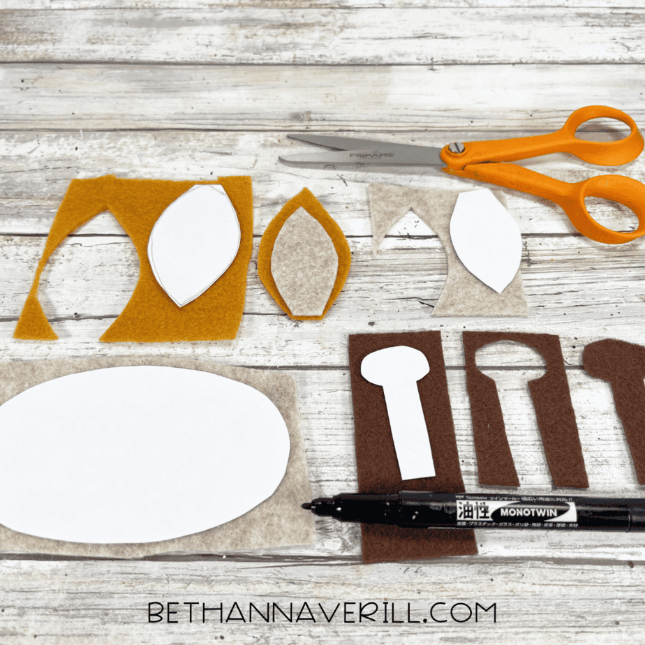 Paper templates traced on felt for giraffe ears, muzzle, and ossicones.