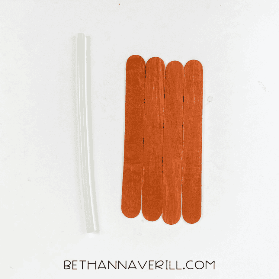 Painted popsicle sticks glued together with a clear glue stick.