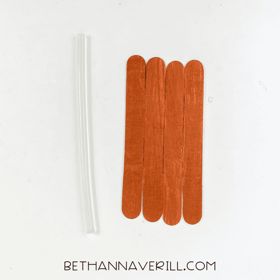 Painted popsicle sticks glued together with a clear glue stick.