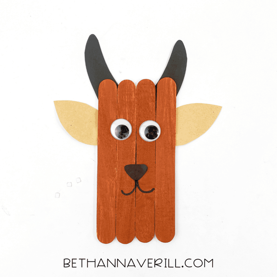 Finished goat popsicle stick craft with horns, ears, and happy face.