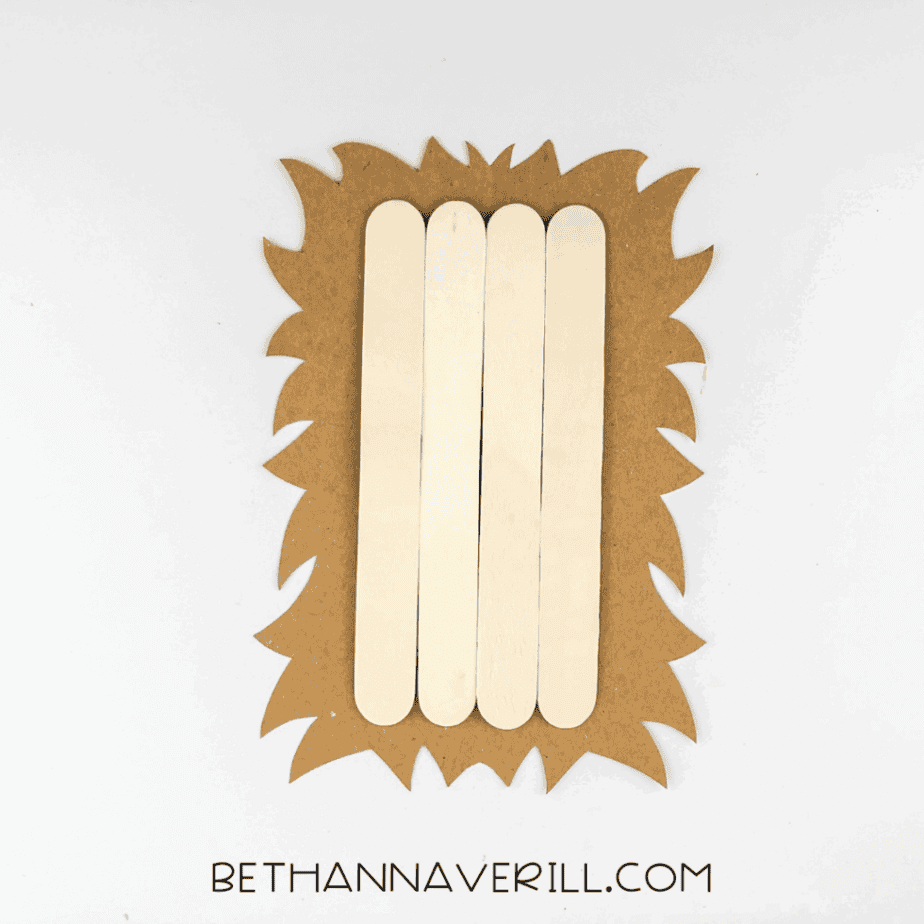Popsicle sticks glued onto the brown spiky oval body.