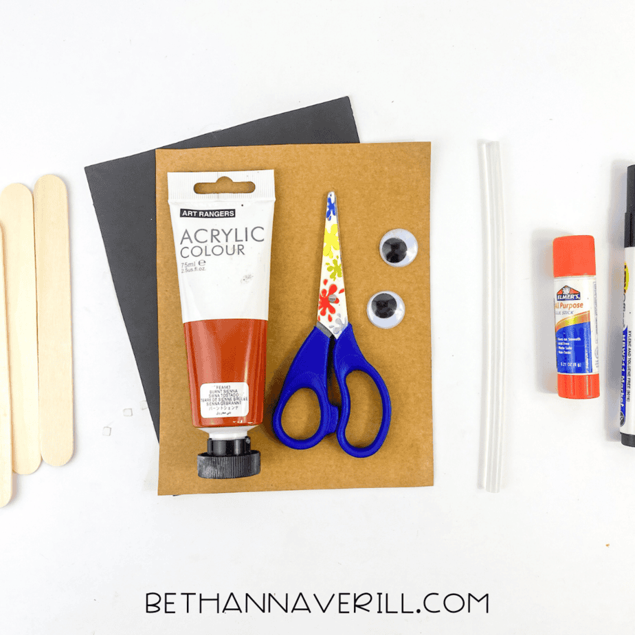 Horse popsicle stick craft materials including paint, paper, googly eyes, glue, and scissors.