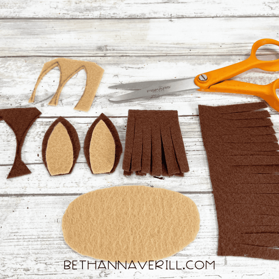 Brown and tan felt pieces cut into ears, muzzle, and mane for horse craft.