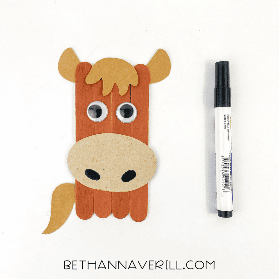 Completed popsicle stick horse craft with black marker nostrils added.