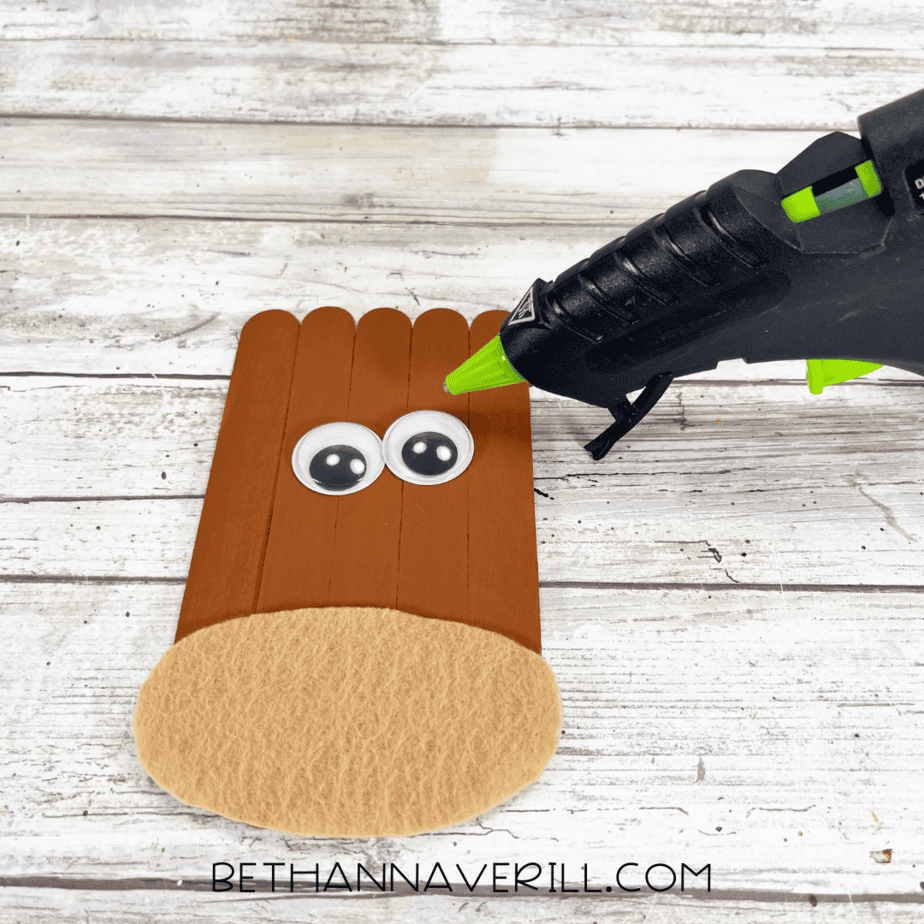 Brown painted craft sticks with tan felt muzzle and googly eyes glued on.