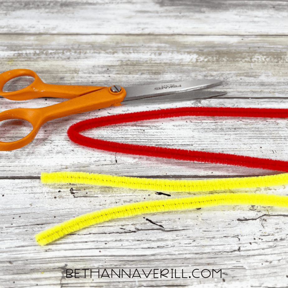 Red and yellow pipe cleaners before cutting for ketchup and mustard