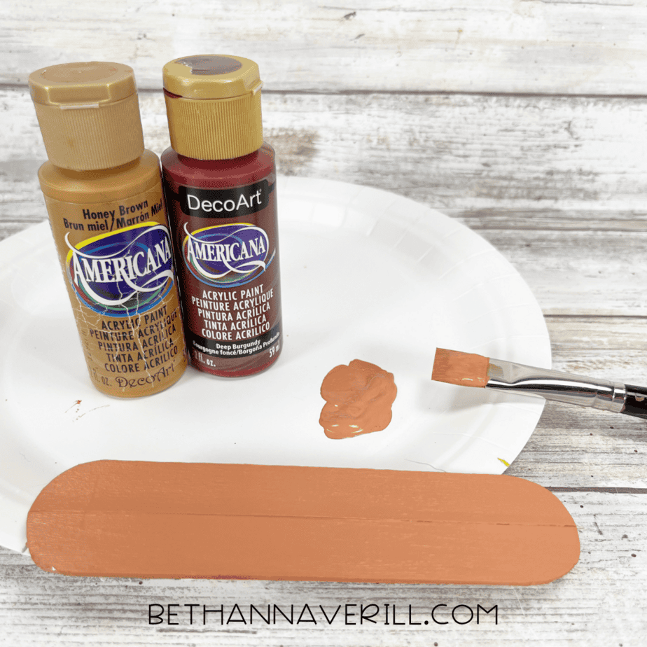 Painted popsicle stick hot dog piece with honey brown and burgundy paint mixture