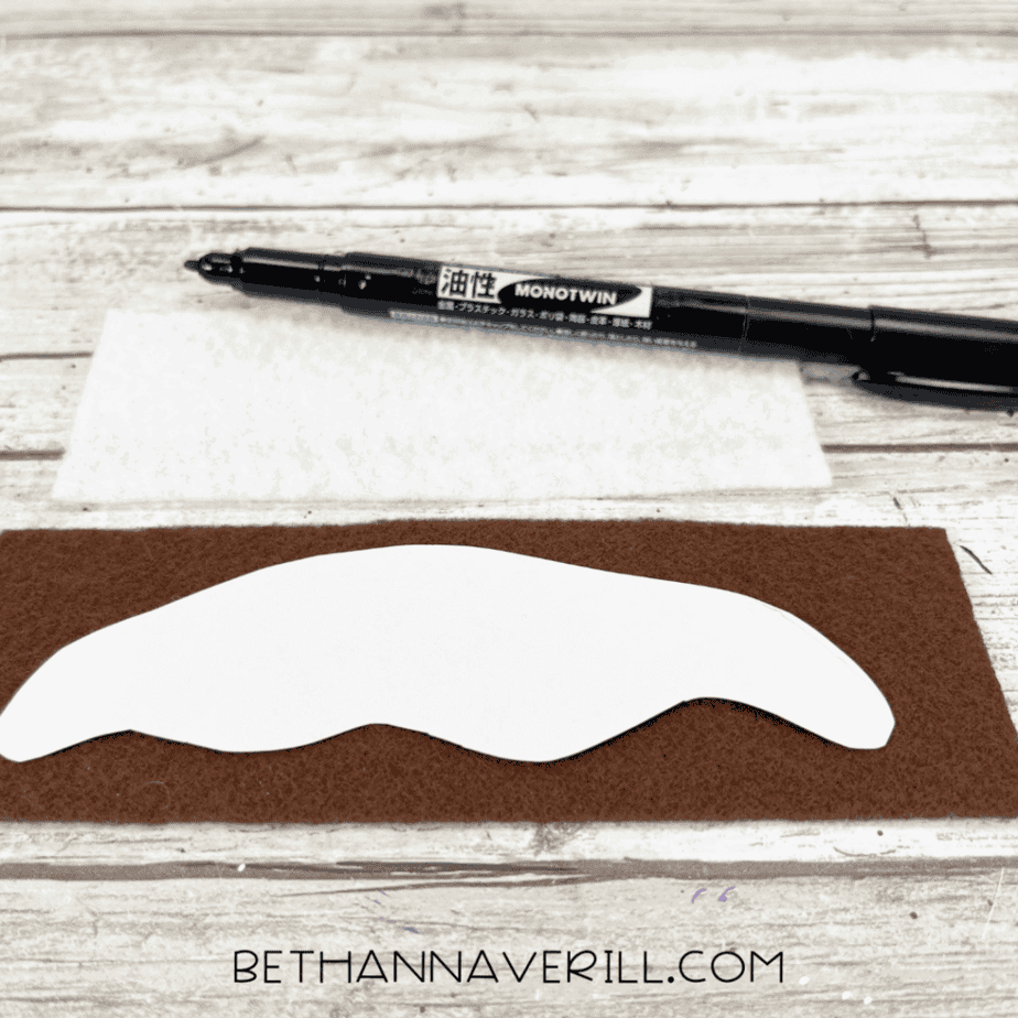 Ice cream sauce template placed on brown felt, ready to be traced with a black marker.
