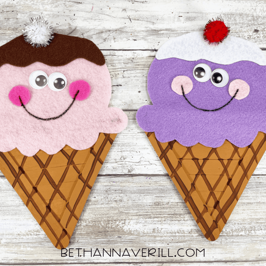 Completed ice cream crafts with googly eyes, pink cheeks, pom-pom cherries, and drawn-on smiles.
