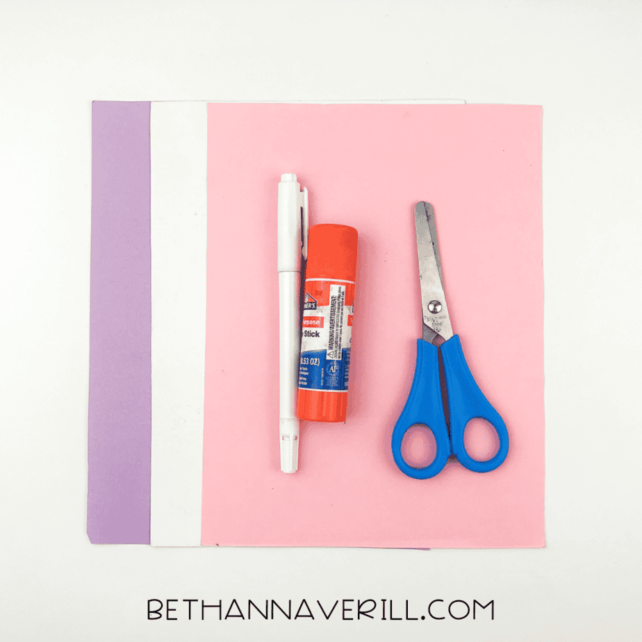 Materials for jellyfish handprint craft: colored paper, scissors, glue stick, markers