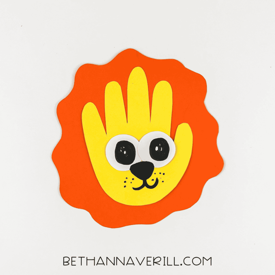 Yellow handprint glued onto orange mane background.