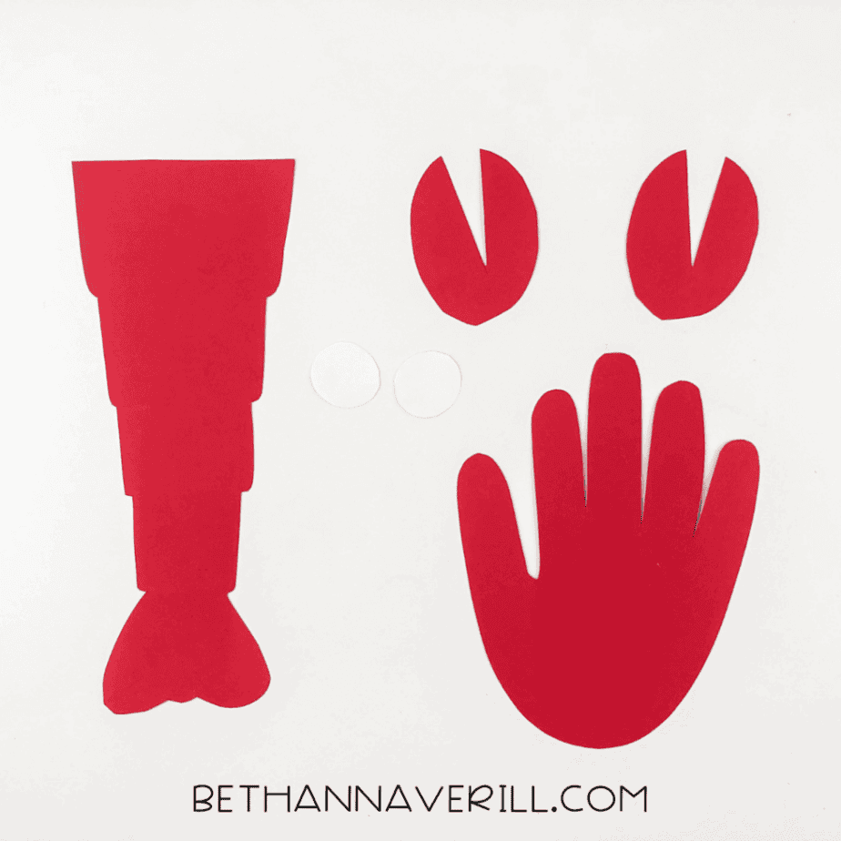 Lobster pieces cut out: body, claws, handprint, and white circles for eyes.