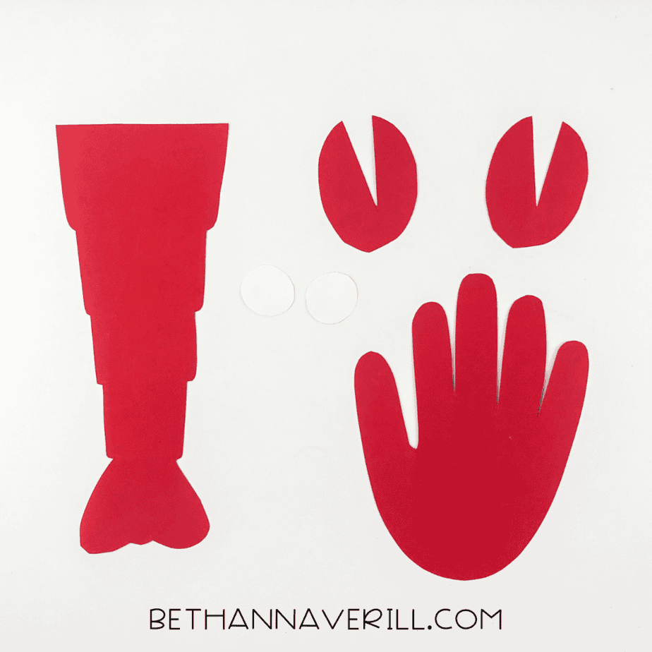 Lobster pieces cut out: body, claws, handprint, and white circles for eyes.