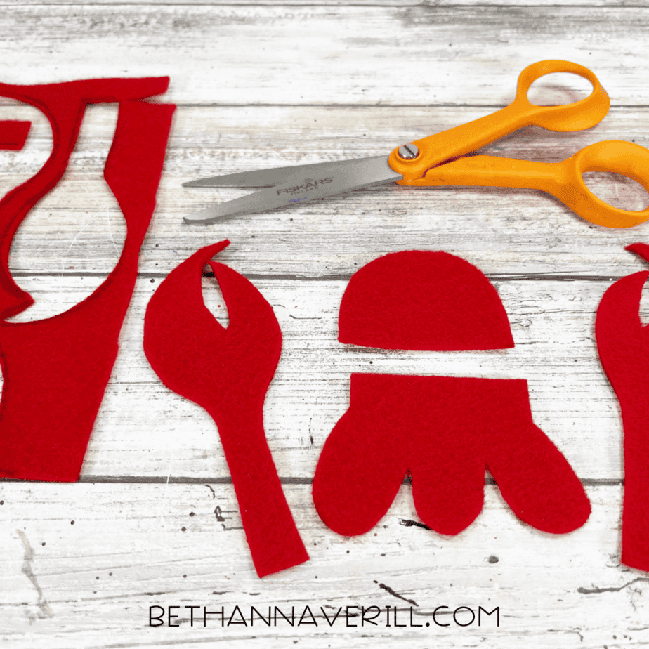Red felt lobster parts cut out with scissors