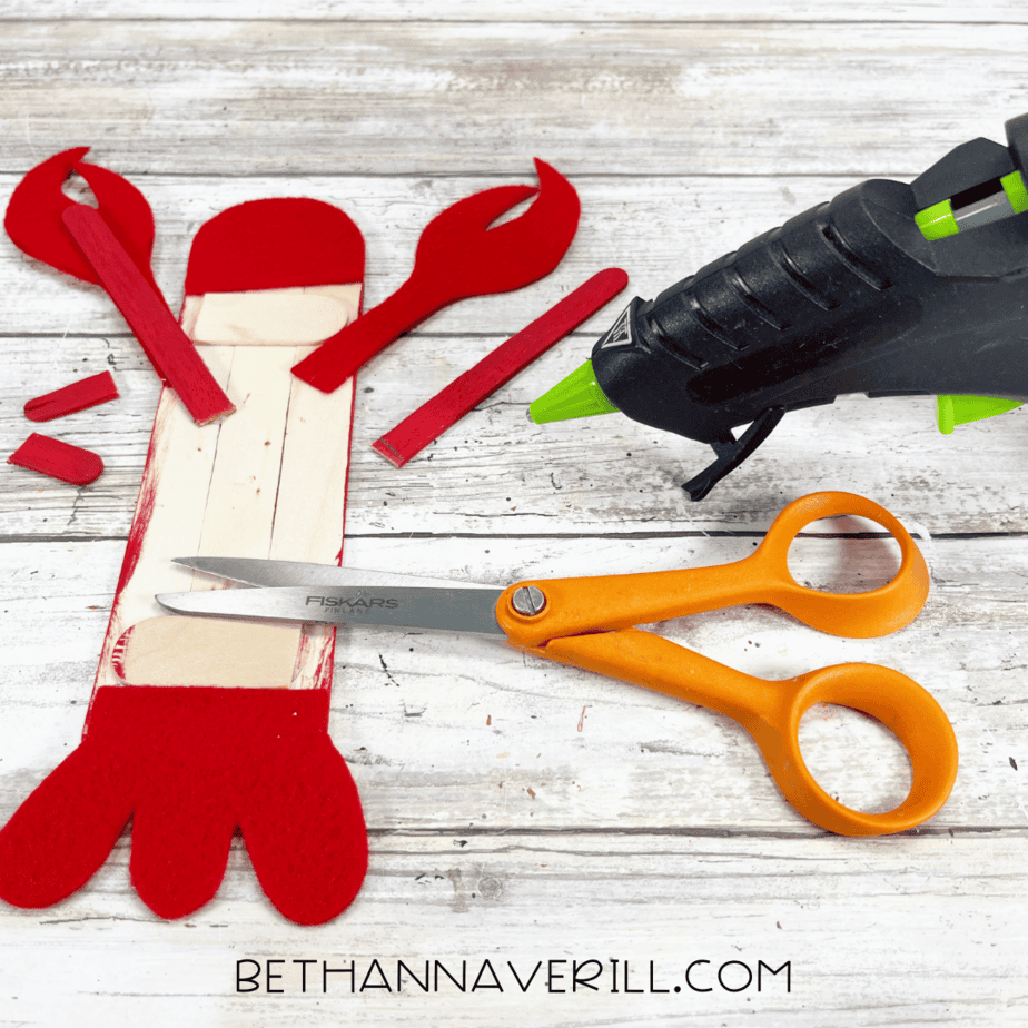 Lobster tail and claws glued onto painted popsicle sticks