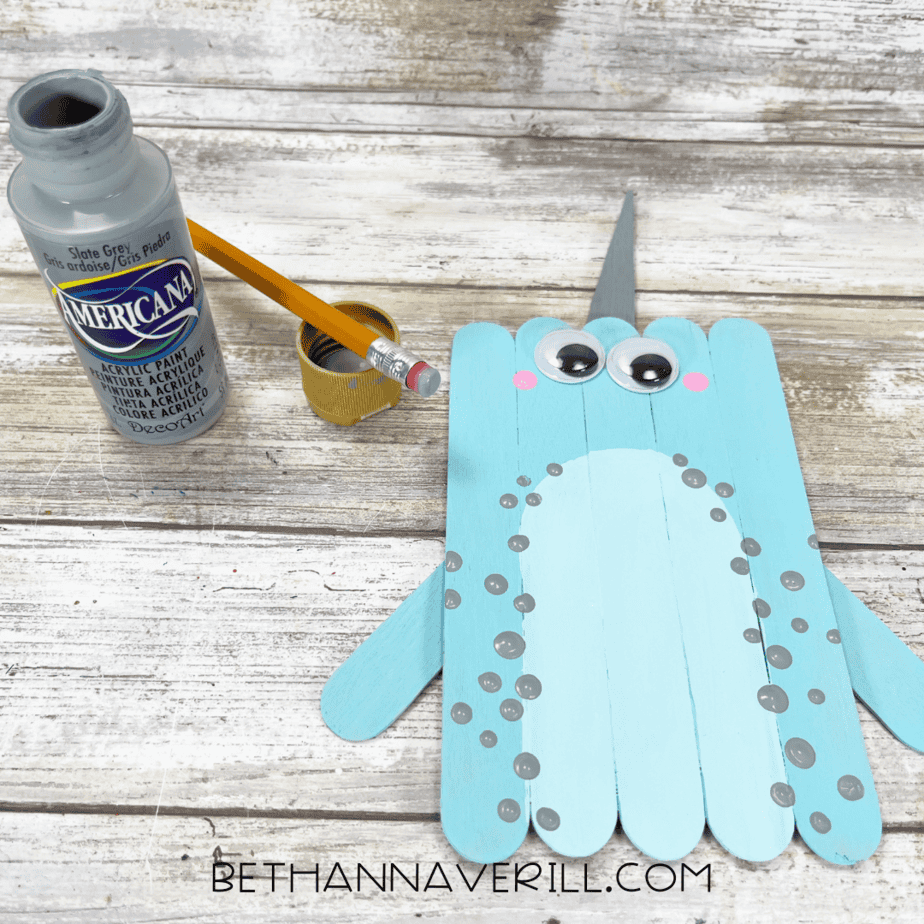 Gray dots stamped around the belly using a pencil eraser.