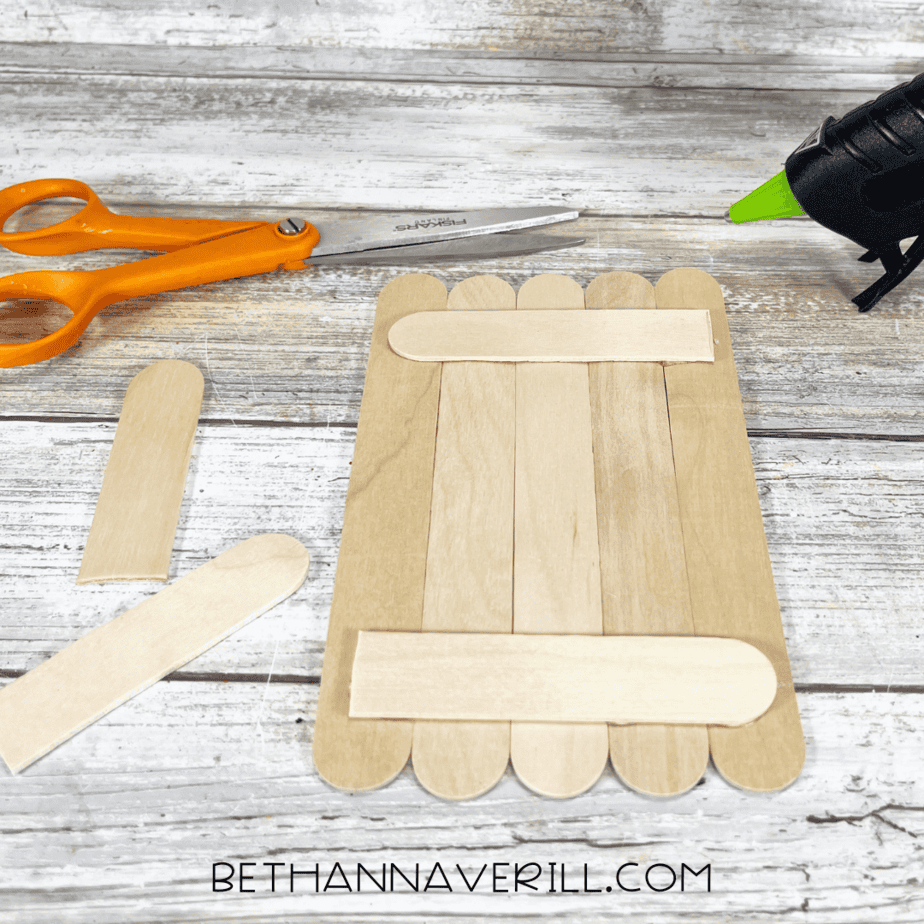 Five popsicle sticks glued side-by-side with support sticks on the back.