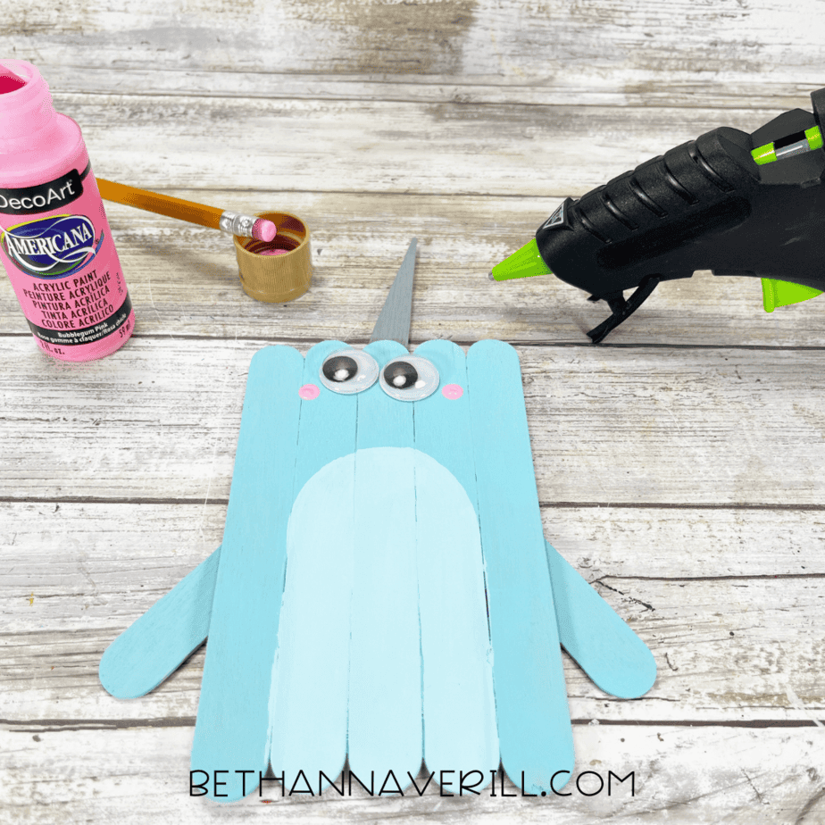 Googly eyes and pink cheeks added to the narwhal face.