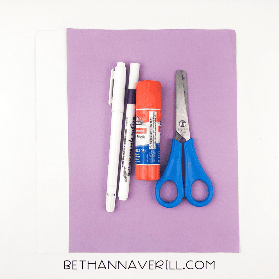 Materials for octopus craft including glue, scissors, markers, and purple construction paper