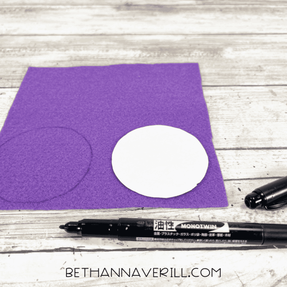 Purple felt with a traced circle and marker.